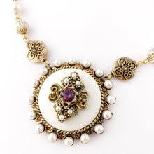 Load image into Gallery viewer, close up of a circular white pendant embellished with faux pearl beads and amethyst rhinestone
