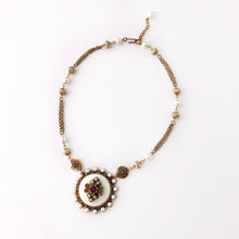 Load image into Gallery viewer, circular white pendant embellished with faux pearl beads and amethyst rhinestone with beaded chain flat on a white background
