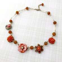 Load image into Gallery viewer, necklace made from repurposed earrings and pressed glass beads flat on a muted background
