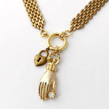 Load image into Gallery viewer, detail of necklace with front ring closure decorated with a lady&#39;s hand and heart shaped padlock charm

