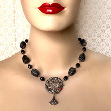 Load image into Gallery viewer, necklace in silvery greys with a red rhinestone set focal displayed on a mannequin

