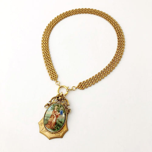 front opening necklace with medieval revival style romantic pendant on a white background