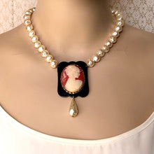 Load image into Gallery viewer, necklace featuring a vintage cameo on a black frame with baroque styled pearl beads displayed on a mannequin
