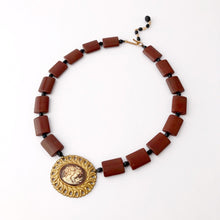 Load image into Gallery viewer, a cameo necklace featuring two women and a bird, with chocolate brown and black beads on a white background
