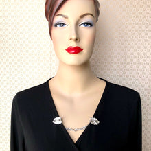 Load image into Gallery viewer, mannequin wearing a wrap dress with a sweater guard made from vintage Sarah Coventry clip back earrings
