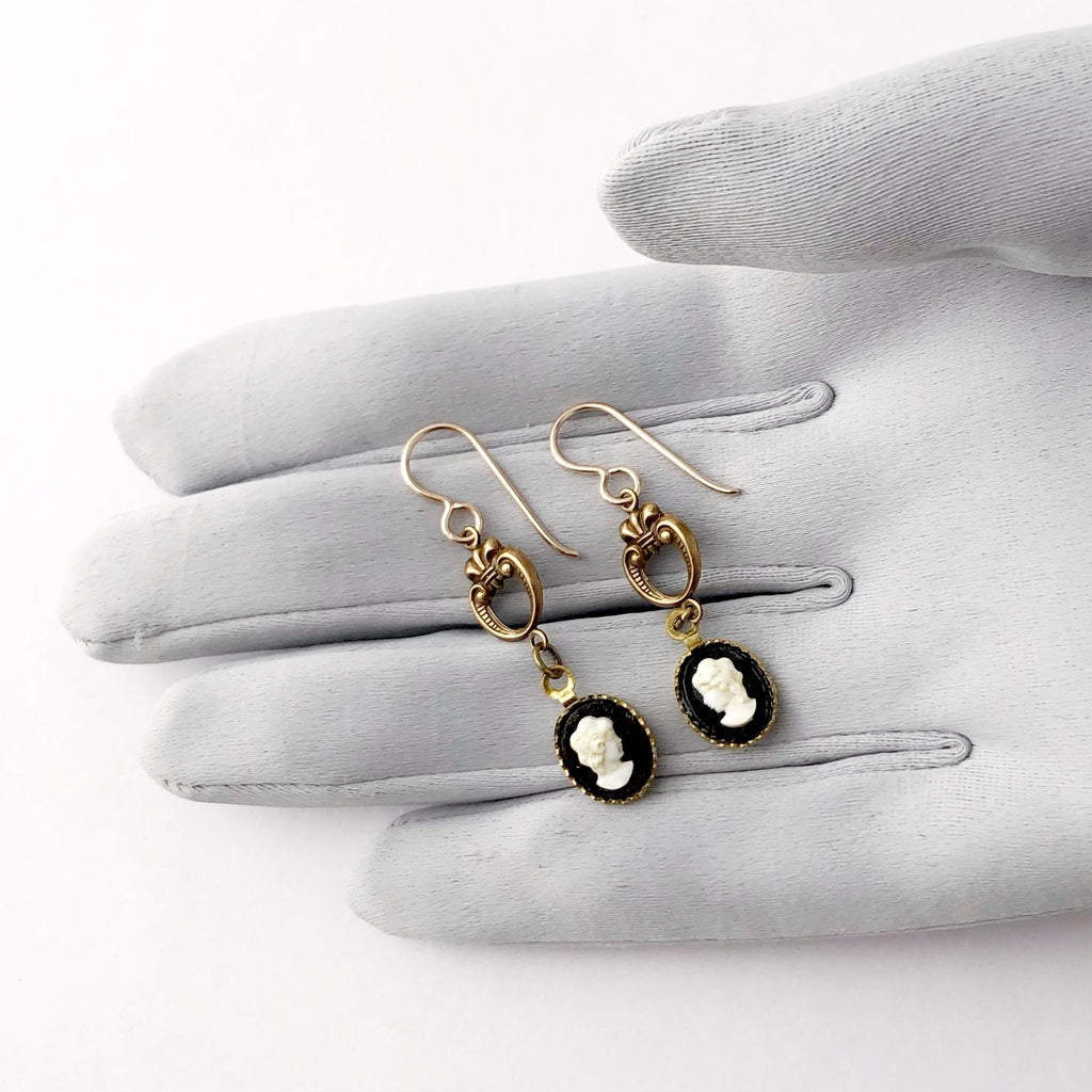 earrings made with vintage black and white cameos  displayed on a grey gloved hand
